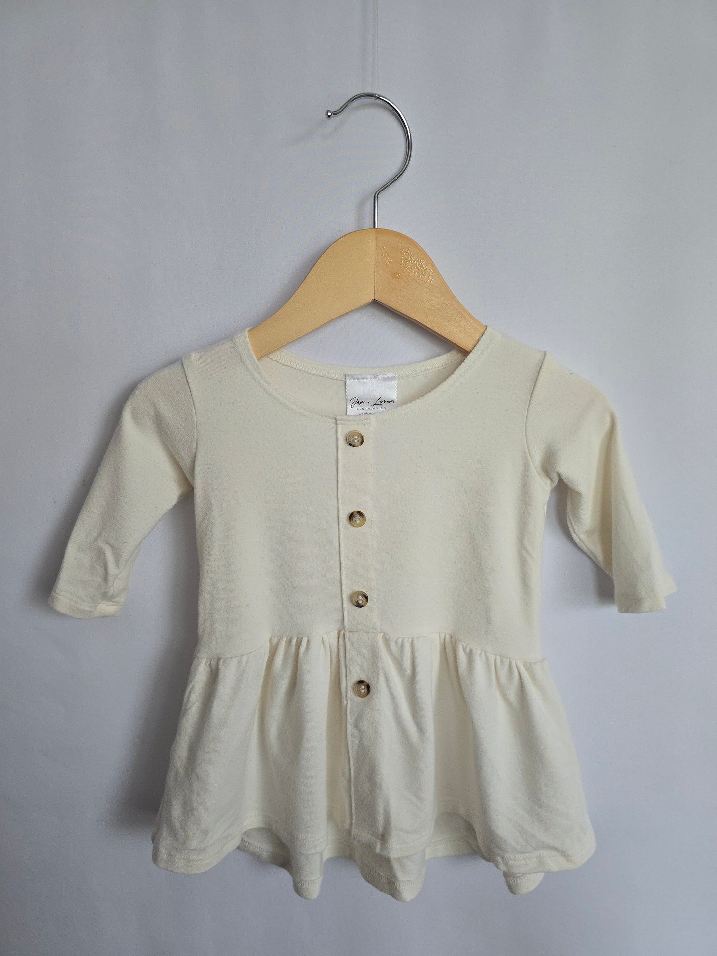 Jax & Lennon Off White Peplum • 0-6 months